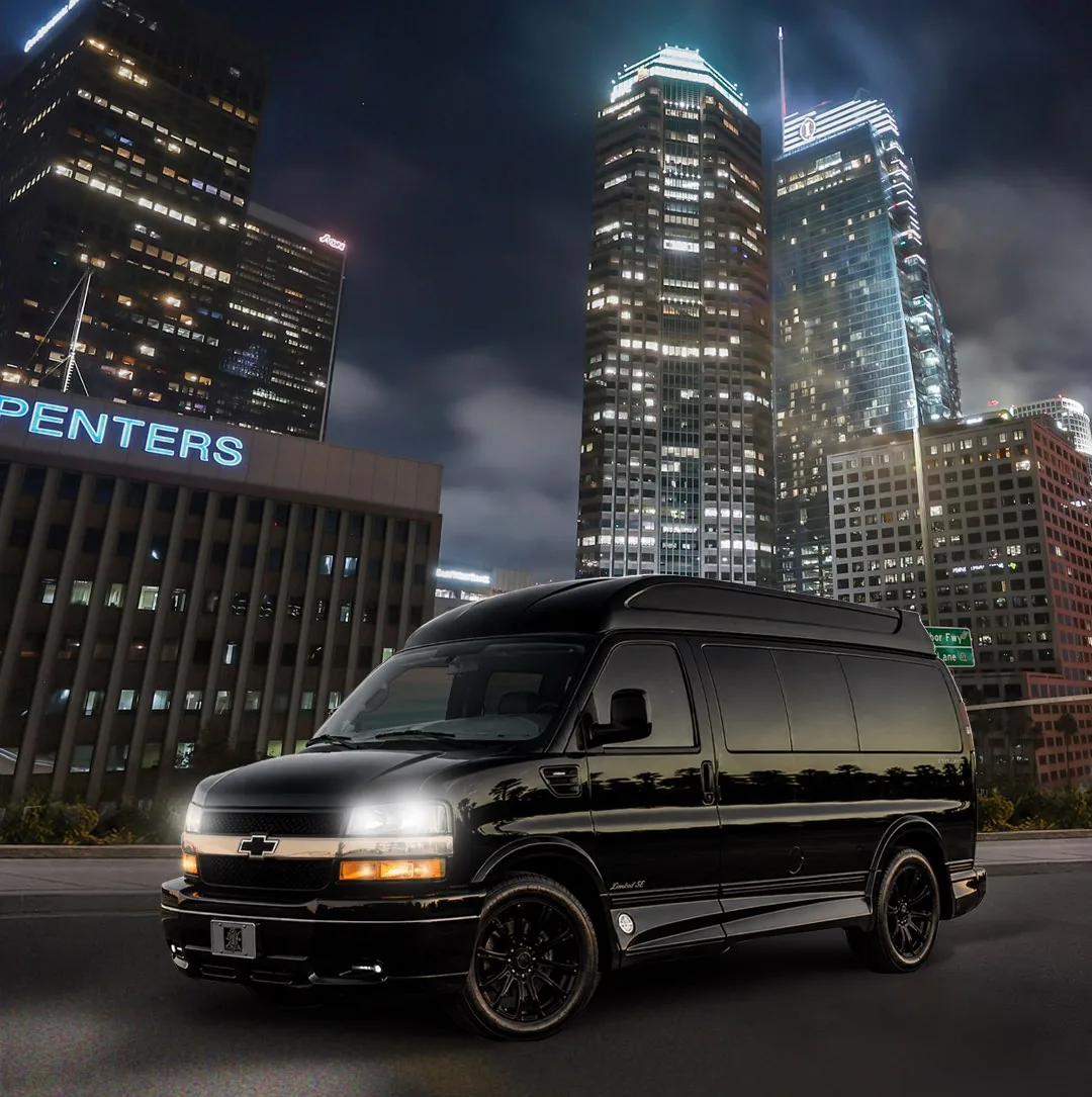 Black 2021 Chevy Express conversion van parked in downtown Los Angeles at night